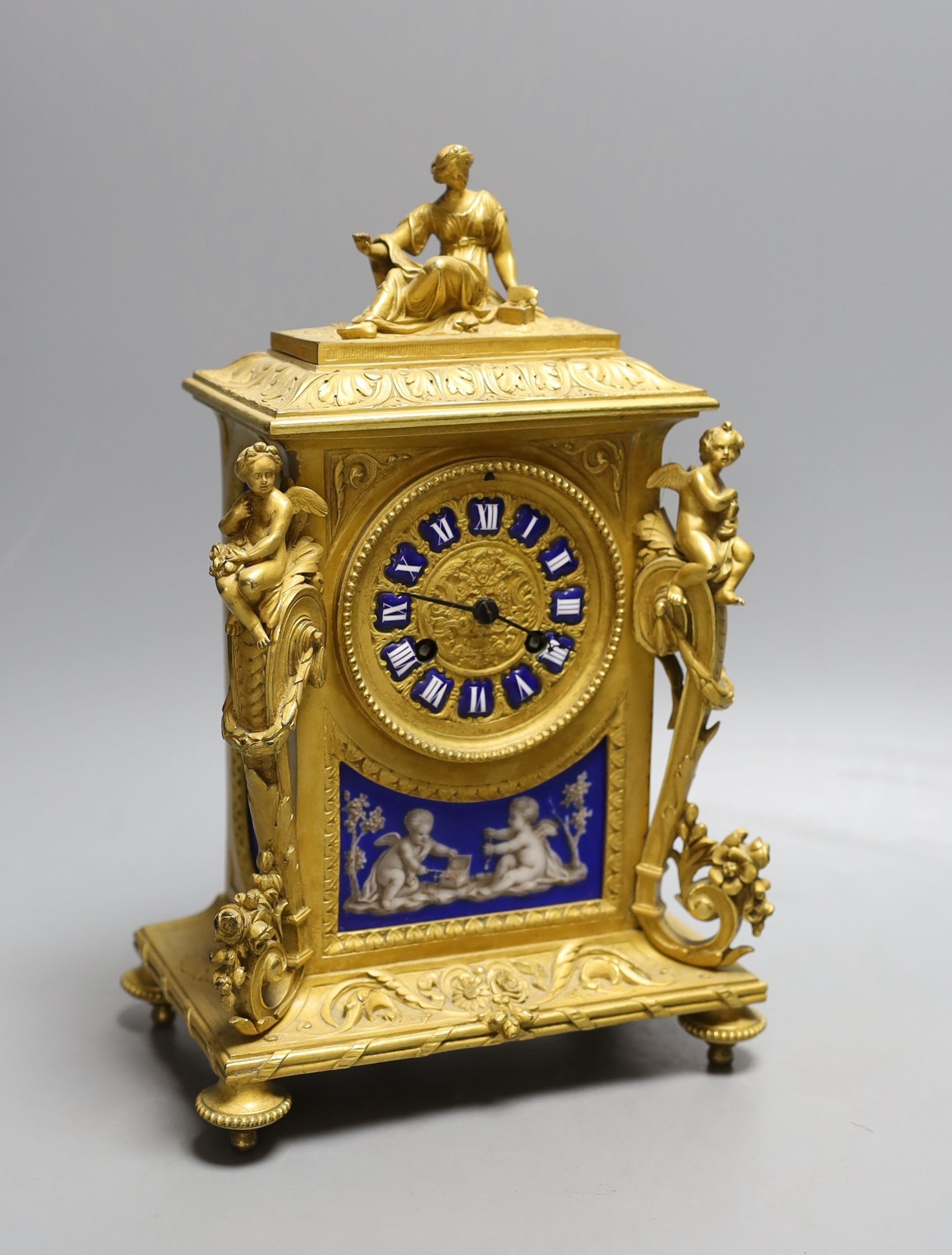 A French ormolu clock with Sevres style blue ground porcelain panels, height 27cm